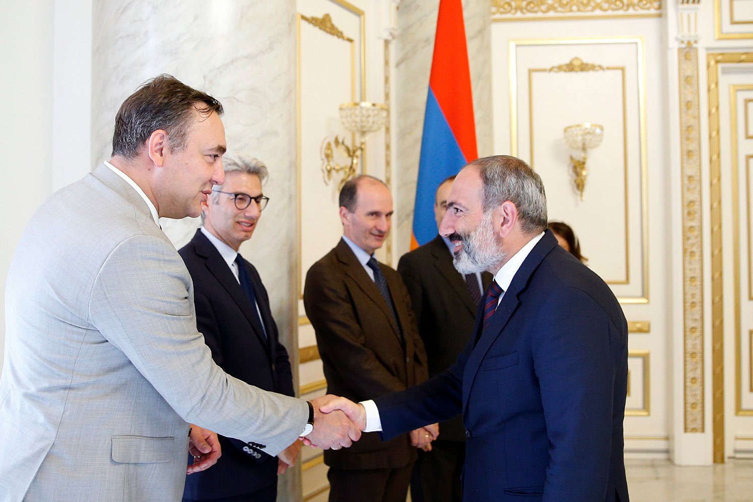 Andrei Muntean shaking hands with the Prime Minister of Armenia